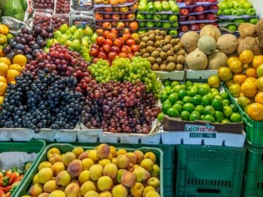green and red apples on blue plastic crate
