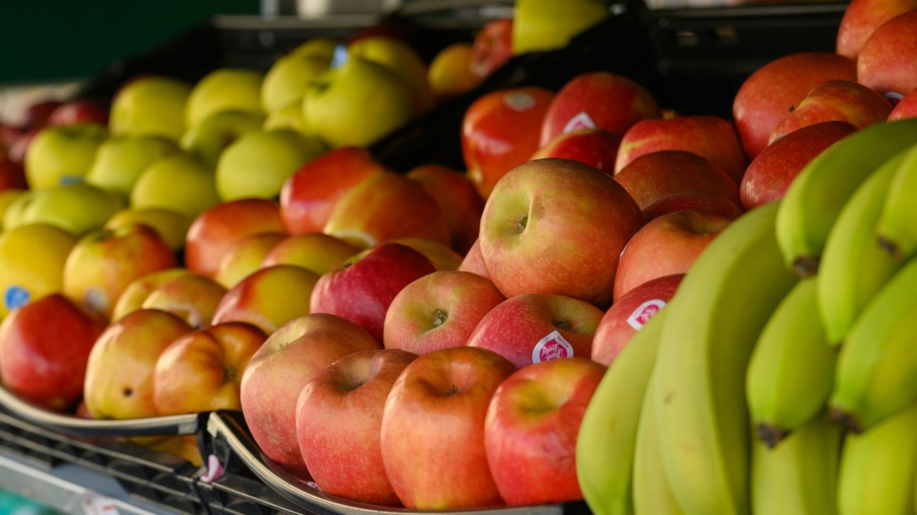 a bunch of apples and bananas are on display